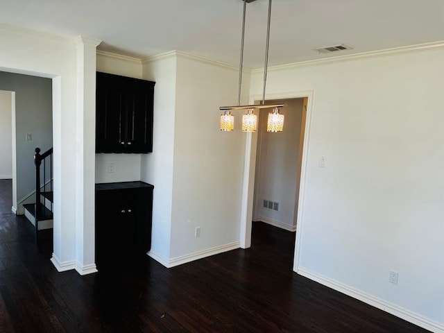 unfurnished dining area featuring crown molding and dark wood-type flooring