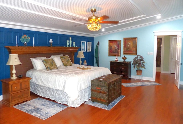 bedroom featuring ceiling fan, hardwood / wood-style floors, crown molding, and lofted ceiling