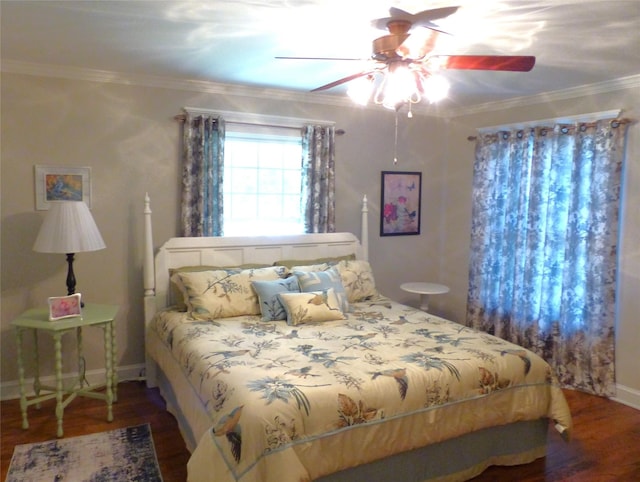 bedroom with dark wood-type flooring, ceiling fan, and crown molding