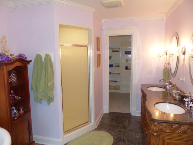 bathroom with a shower with door, crown molding, and vanity