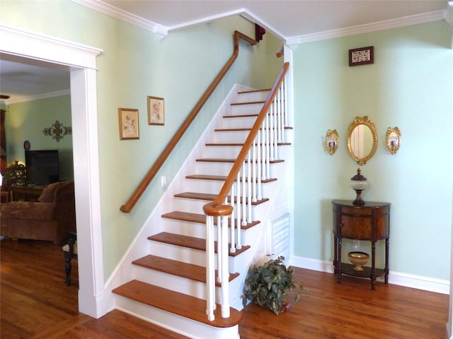 stairway featuring ornamental molding and wood-type flooring