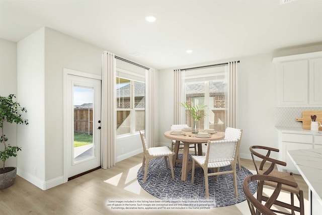 dining space with light hardwood / wood-style floors