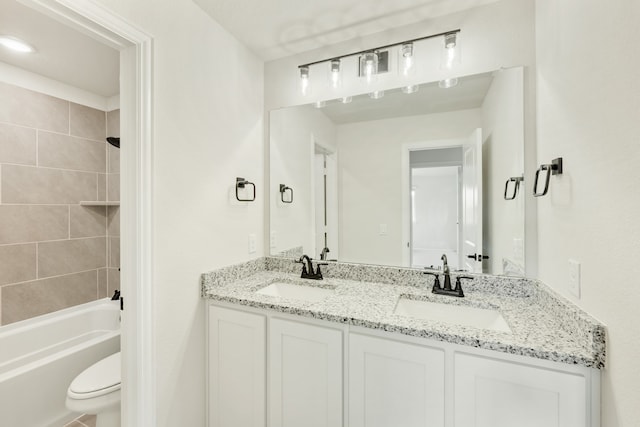 full bathroom featuring vanity, toilet, and tiled shower / bath