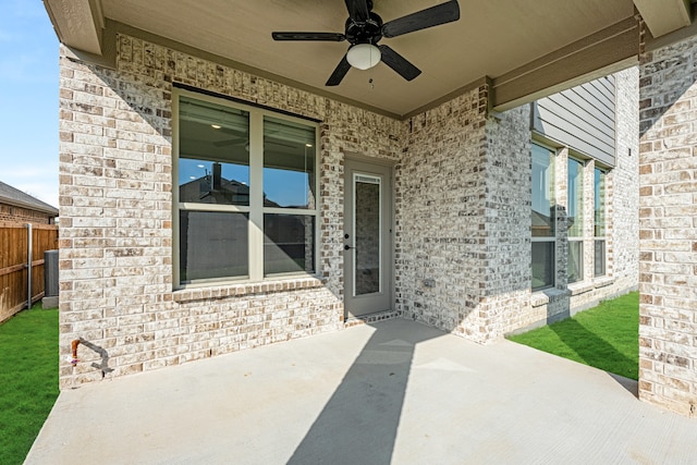 property entrance with a patio area and ceiling fan