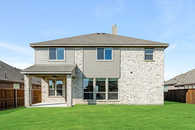 rear view of property with a yard and a patio area