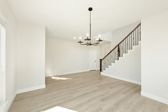 interior space featuring light hardwood / wood-style flooring and an inviting chandelier