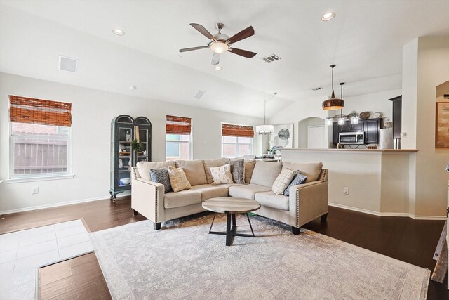 living room featuring dark hardwood / wood-style flooring and ceiling fan