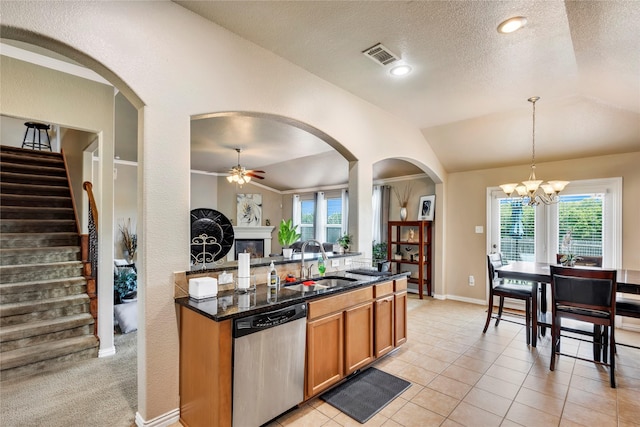 kitchen with ceiling fan with notable chandelier, vaulted ceiling, sink, dishwasher, and hanging light fixtures