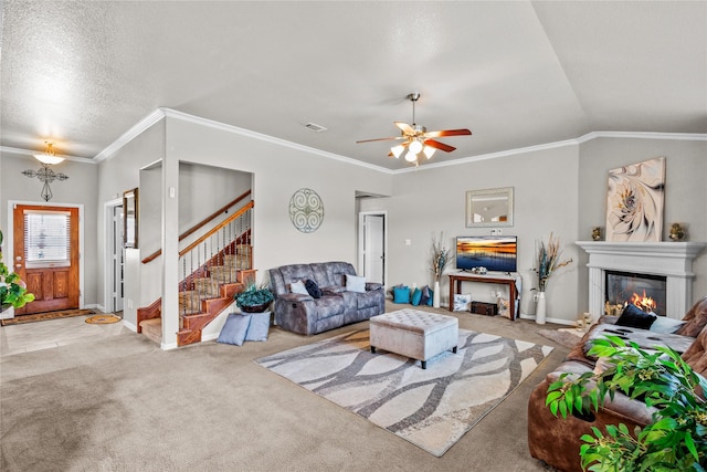 carpeted living room featuring vaulted ceiling, ceiling fan, and crown molding