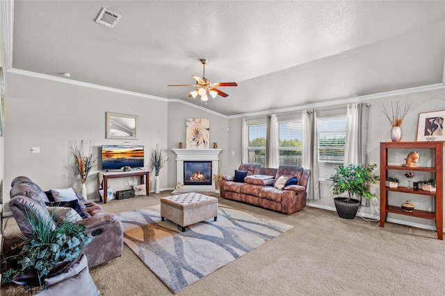 living room with ceiling fan, lofted ceiling, light carpet, and ornamental molding