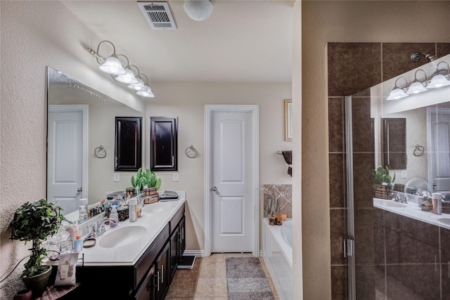 bathroom featuring tile patterned floors, vanity, and shower with separate bathtub