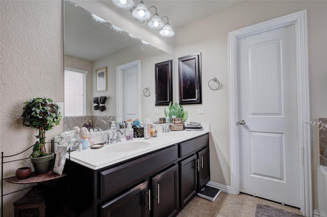 bathroom featuring tile patterned flooring and vanity