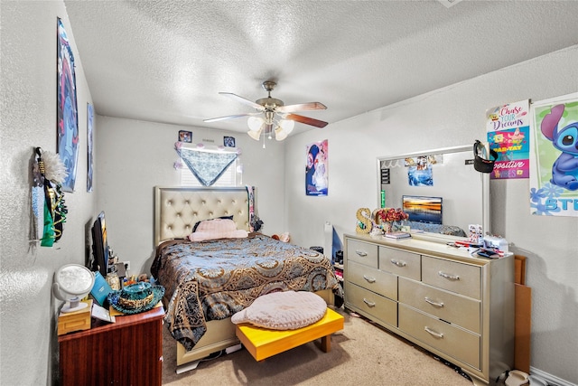 carpeted bedroom featuring ceiling fan and a textured ceiling