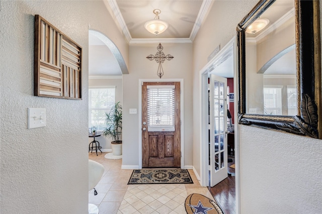 tiled foyer entrance featuring ornamental molding