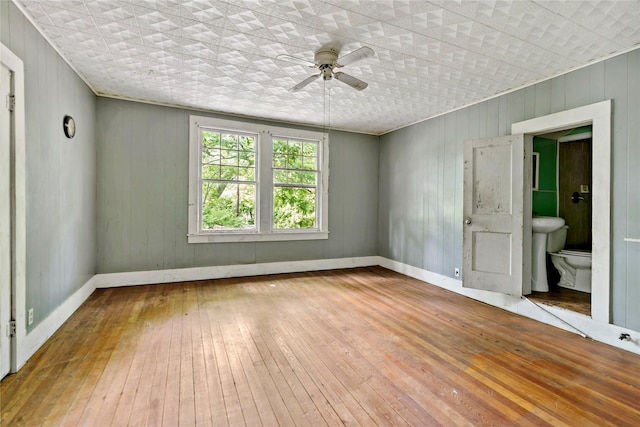 spare room with wood-type flooring and ceiling fan