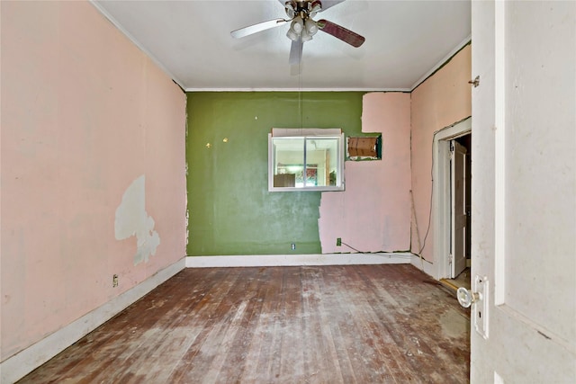 spare room with wood-type flooring, ornamental molding, and ceiling fan