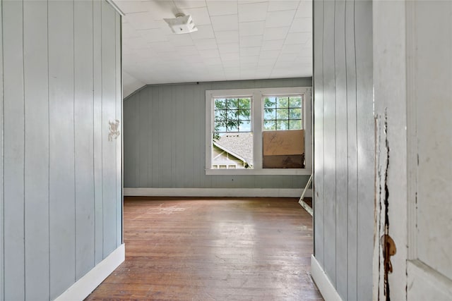 additional living space featuring hardwood / wood-style floors and lofted ceiling