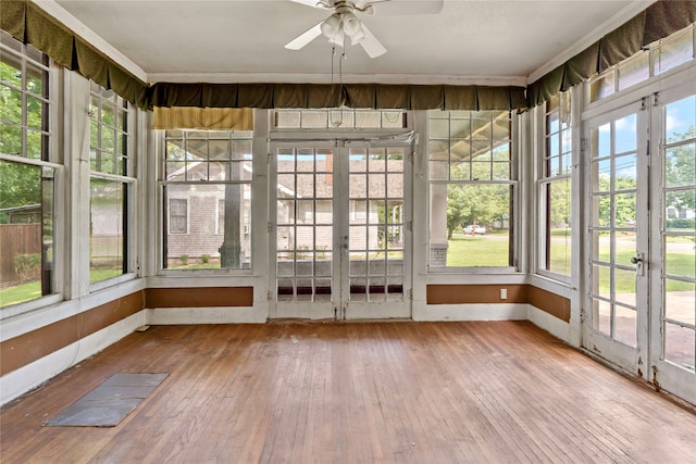 unfurnished sunroom featuring ceiling fan