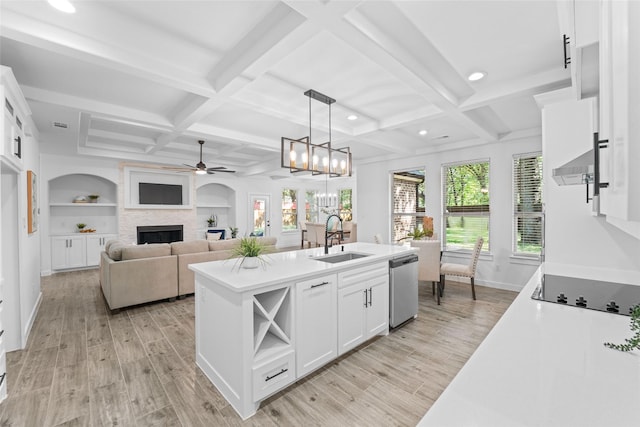 kitchen featuring pendant lighting, dishwasher, white cabinets, sink, and built in shelves