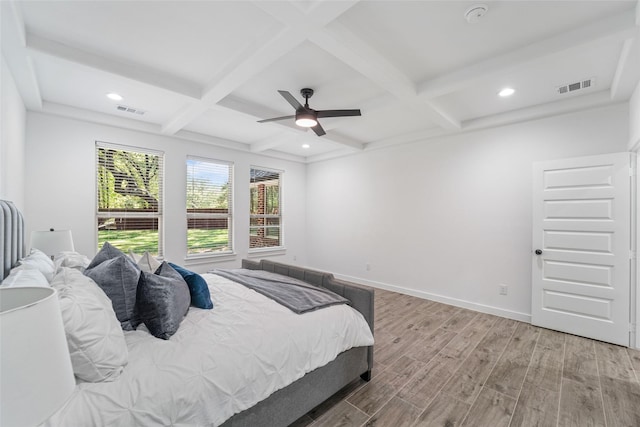 bedroom featuring wood-type flooring, ceiling fan, coffered ceiling, and beam ceiling