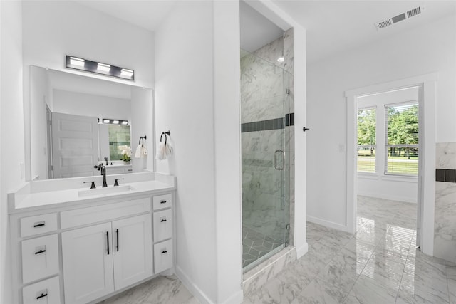 bathroom with vanity and a shower with shower door