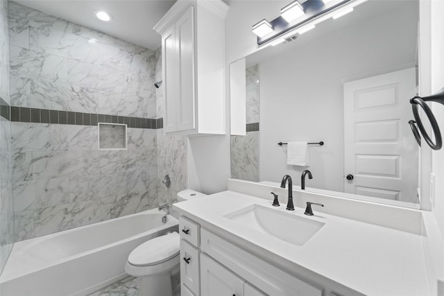 full bathroom with toilet, vanity, and tiled shower / bath