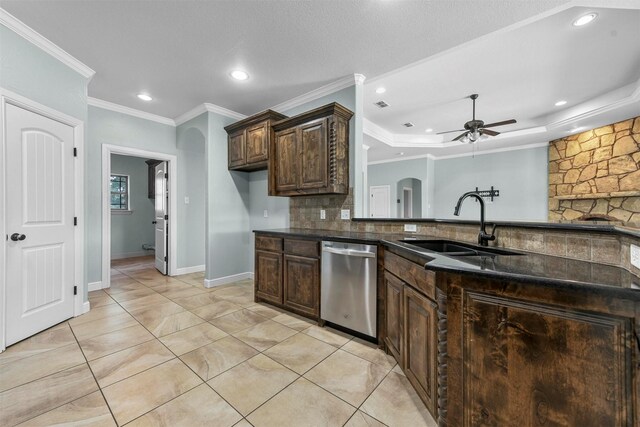 kitchen with sink, stainless steel dishwasher, ceiling fan, dark brown cabinetry, and a textured ceiling