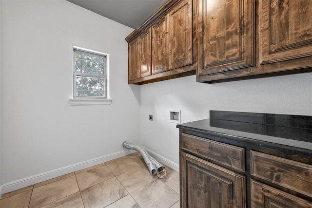 clothes washing area with washer hookup, cabinets, light tile patterned floors, and electric dryer hookup