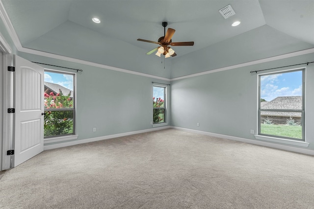 spare room with a raised ceiling, ceiling fan, ornamental molding, and light carpet