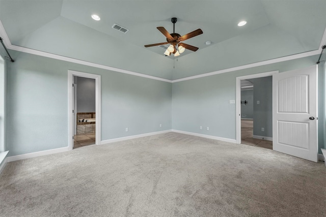 unfurnished bedroom with light colored carpet, ceiling fan, a towering ceiling, and ensuite bathroom