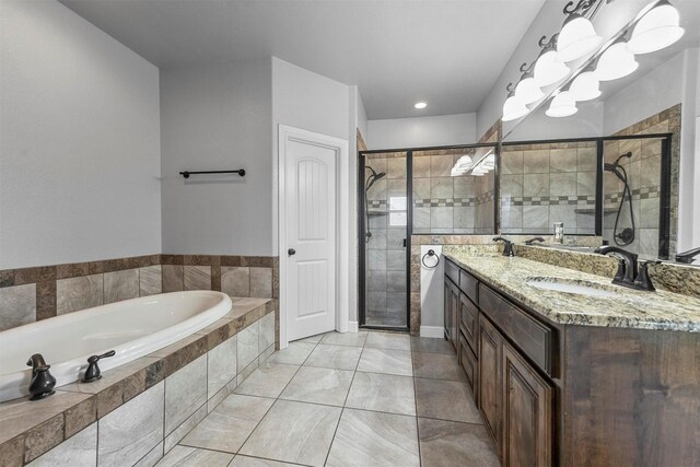 bathroom featuring tile patterned flooring, vanity, separate shower and tub, and an inviting chandelier