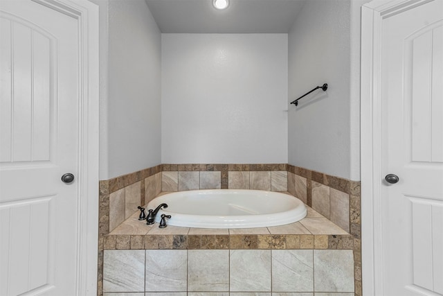 bathroom featuring a relaxing tiled tub