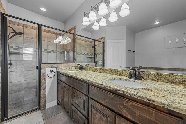 bathroom featuring vanity, a shower with shower door, and tile patterned floors