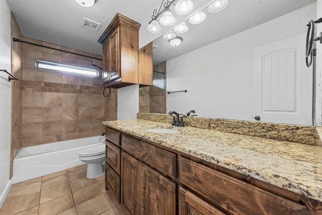 full bathroom with tile patterned flooring, vanity, toilet, and tiled shower / bath