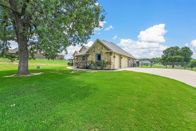 view of front facade with a garage and a front lawn