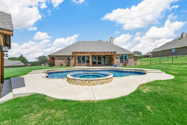 view of swimming pool with a yard, a patio area, and an in ground hot tub