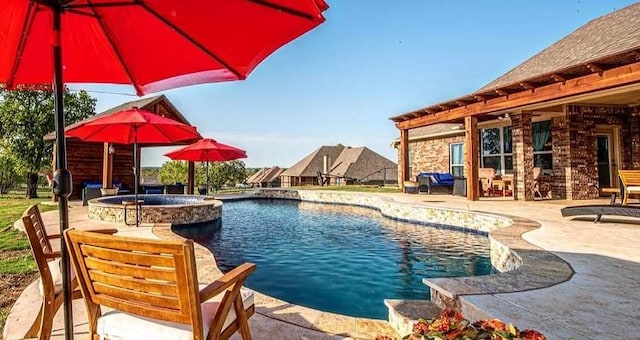 view of swimming pool with an in ground hot tub and a patio