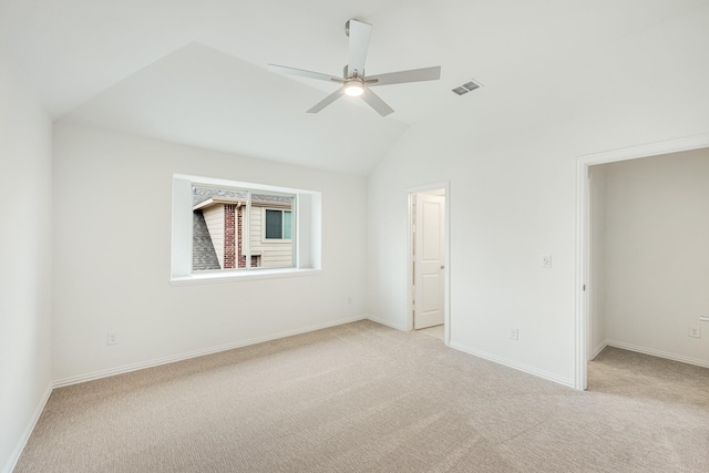 unfurnished bedroom featuring vaulted ceiling, light carpet, and ceiling fan