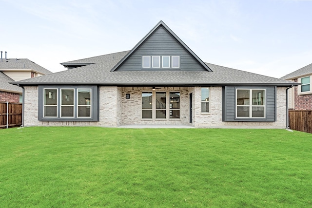 back of house featuring a lawn