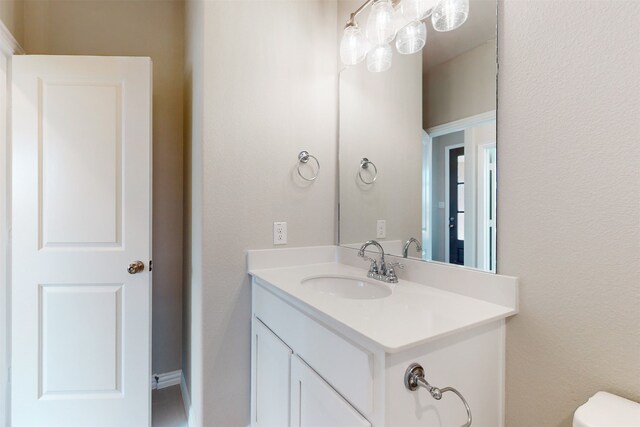 bathroom featuring vanity and toilet