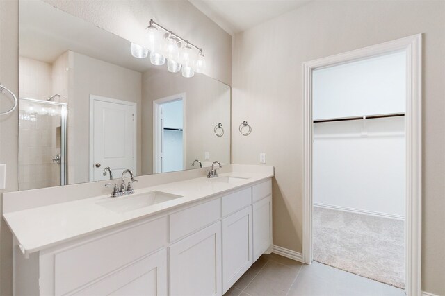 bathroom featuring vanity, walk in shower, and tile patterned flooring