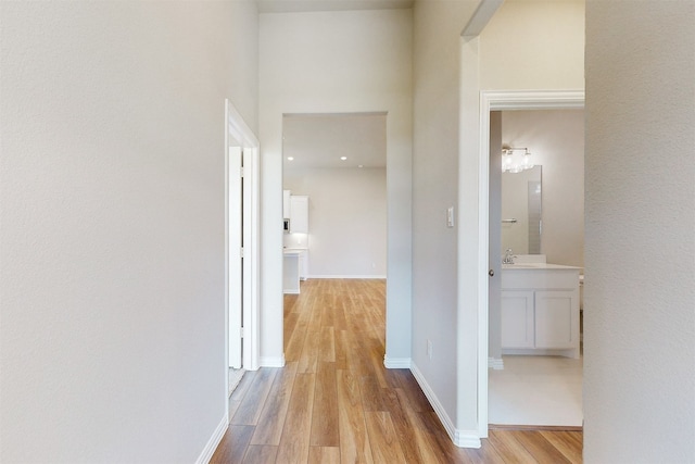 hall featuring sink and light hardwood / wood-style flooring