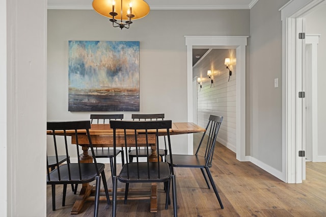 dining room with crown molding and hardwood / wood-style floors