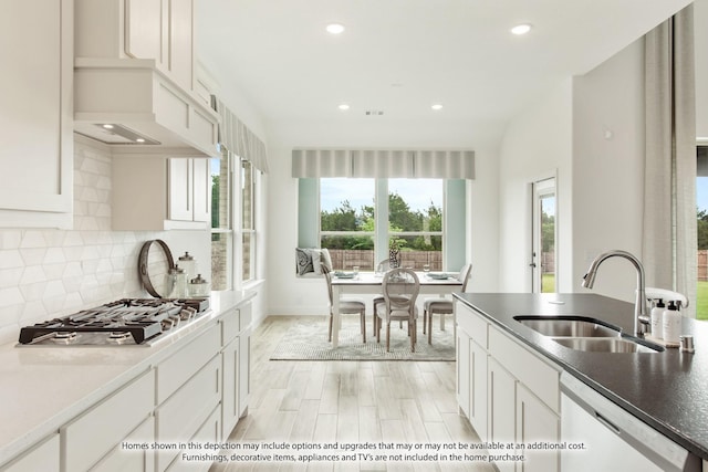 kitchen featuring tasteful backsplash, sink, white cabinets, and appliances with stainless steel finishes