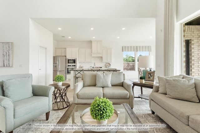 living room featuring a brick fireplace and light hardwood / wood-style flooring