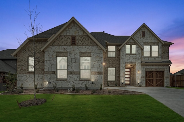 view of front of house with a garage and a lawn