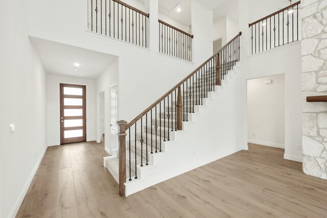 carpeted bedroom featuring a walk in closet, a tray ceiling, and ceiling fan