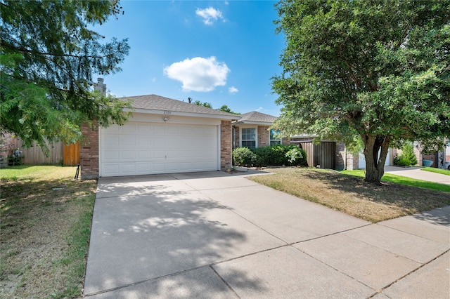 single story home featuring a garage and a front yard