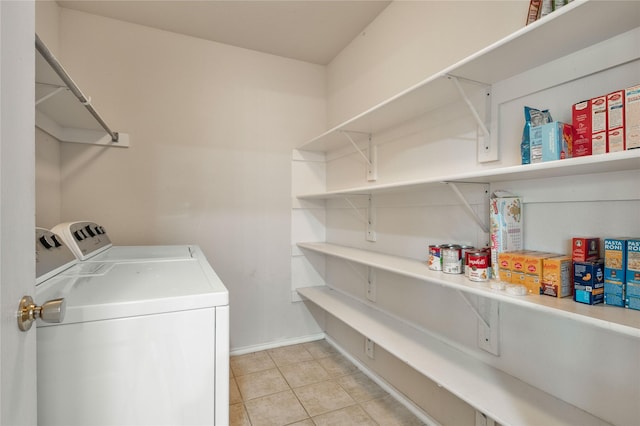 laundry room featuring separate washer and dryer and light tile floors