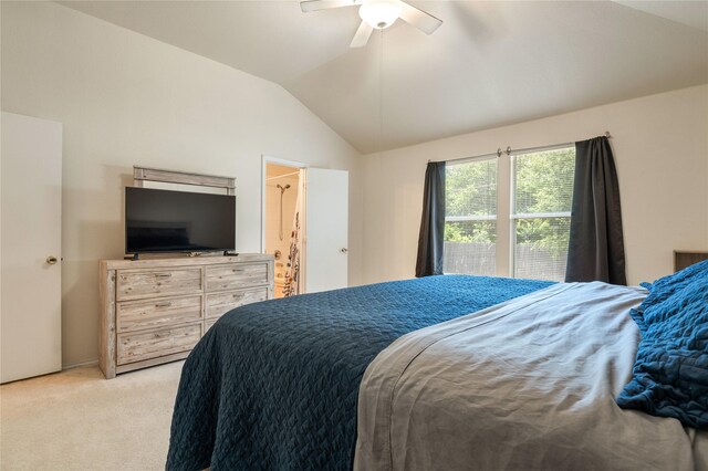 bedroom featuring light carpet, lofted ceiling, and ceiling fan